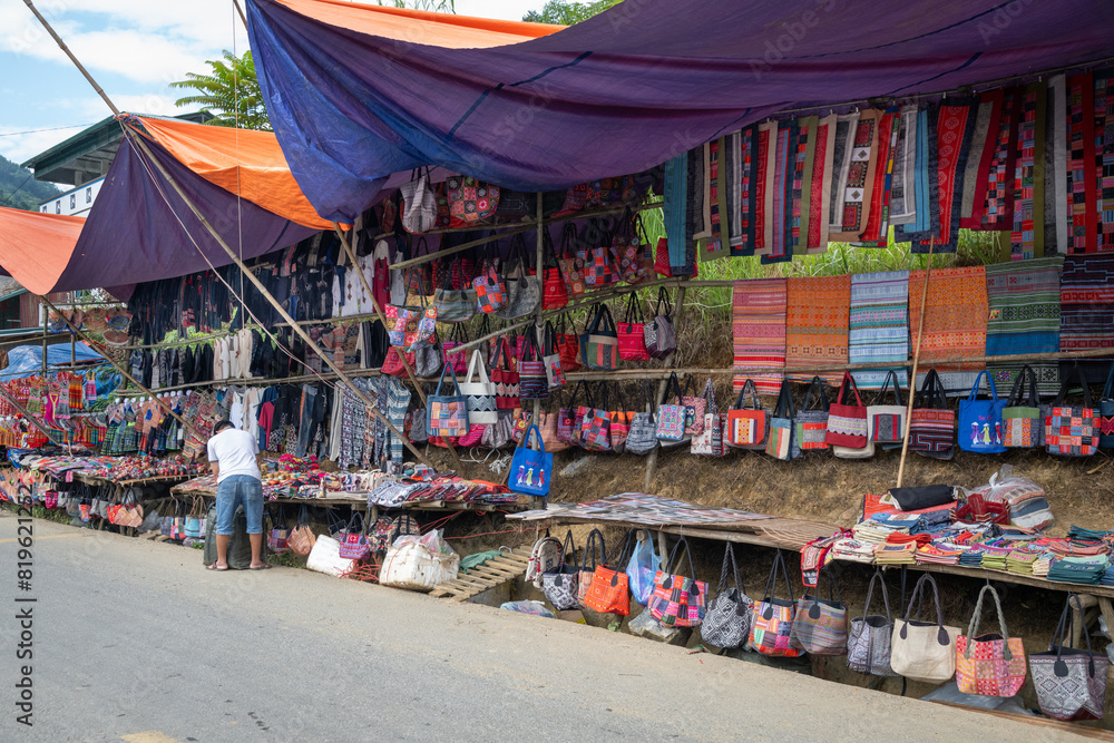 Naklejka premium Colourful traditional items for sale at Can Cau Market in Lao Cai Province, Vietnam