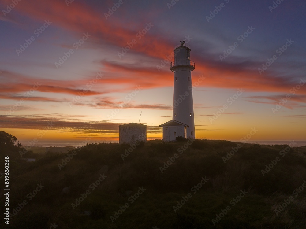 Cape Egmont lighthouse and farm at sunset. Mt Taranaki, Taranaki, New Zealand. Cape Egmont lighthouse and farm at sunset. Mt Taranaki, Taranaki, New Zealand.
