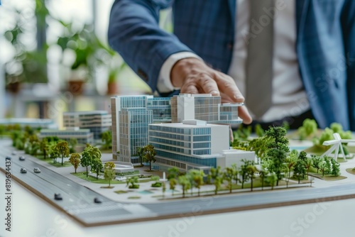 Businessman viewing architects scale model of innovative office complex in real estate development