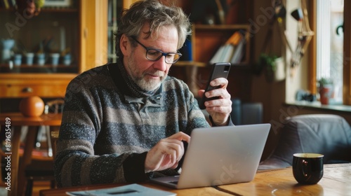Man Multitasking with Laptop and Phone