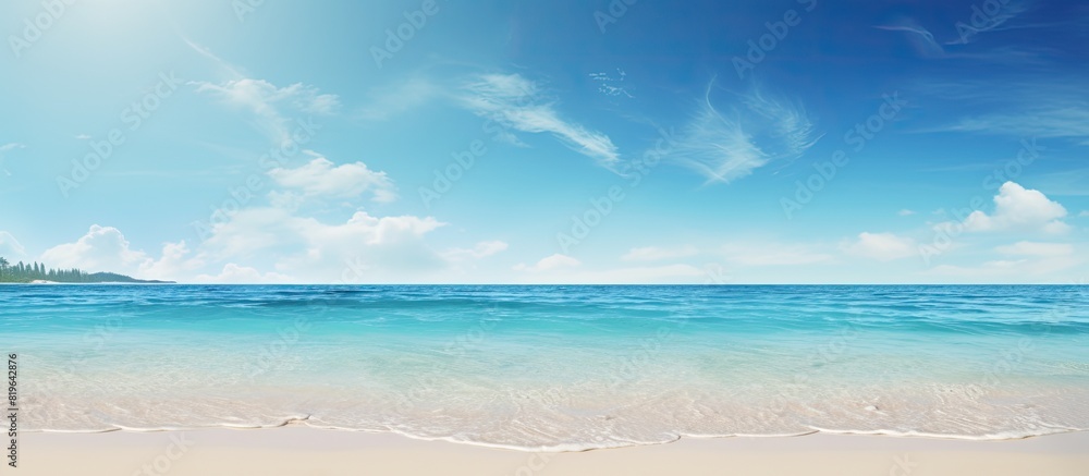 A beach setting with a sunny sky and clear ocean waters perfect for a copy space image