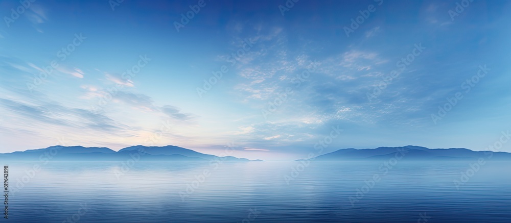 At night a thin layer of clouds covers the blue sky with a slight hint of sunlight remaining creating a tranquil atmosphere in the twilight. Copy space image. Place for adding text and design