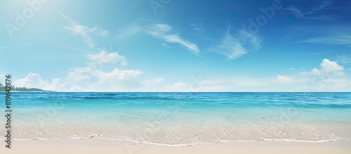 A beach setting with a sunny sky and clear ocean waters perfect for a copy space image