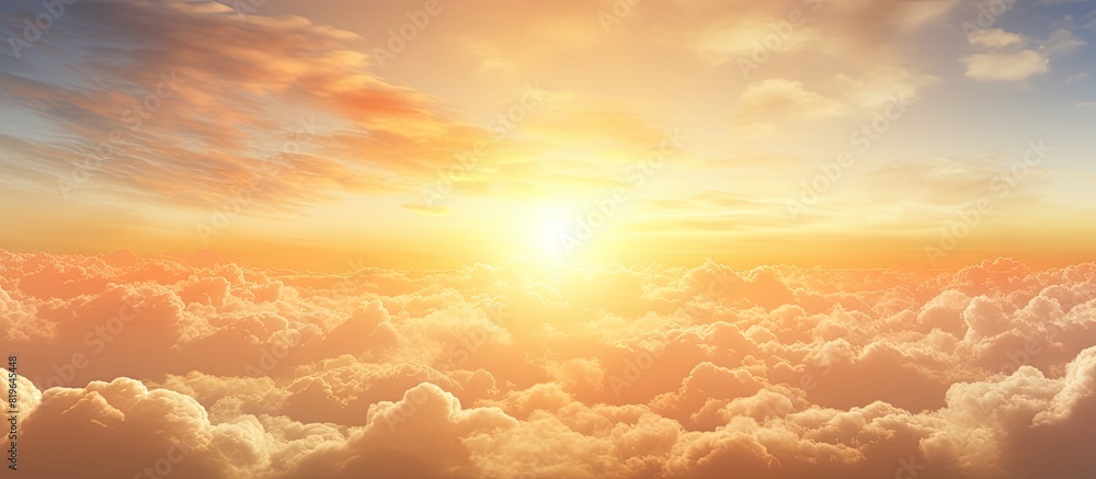Sunrise scenery with fluffy orange and yellow clouds in the early morning creating a beautiful golden hour summer background with copy space image