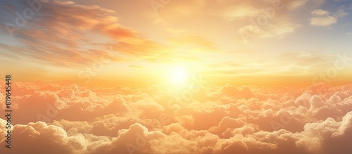 Sunrise scenery with fluffy orange and yellow clouds in the early morning creating a beautiful golden hour summer background with copy space image