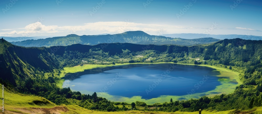 Summer scenery of a volcanic crater lake with a clear blue sky and lush green surroundings ideal for a copy space image