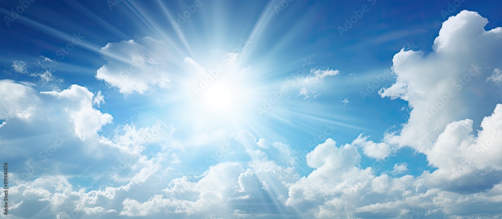 A picturesque scene featuring a bright sun and fluffy clouds against a blue sky ideal for a copy space image