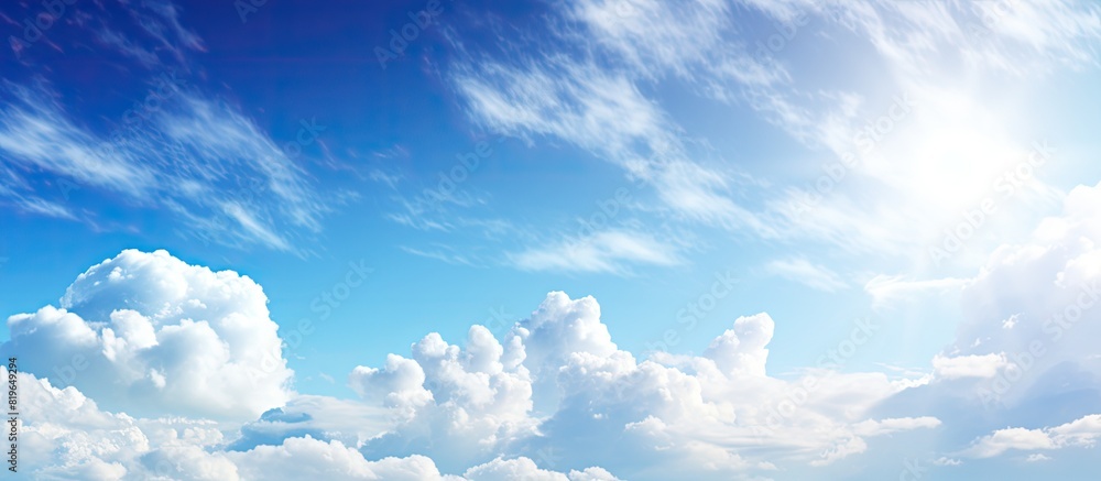 Clear blue sky with fluffy white clouds combined with warm sunshine and a cool breeze against your skin creating a refreshing paradise like scene. Copy space image. Place for adding text and design Clear blue sky with fluffy white clouds combined with warm sunshine and a cool breeze against your skin creating a refreshing paradise like scene. Copy space image. Place for adding text and design