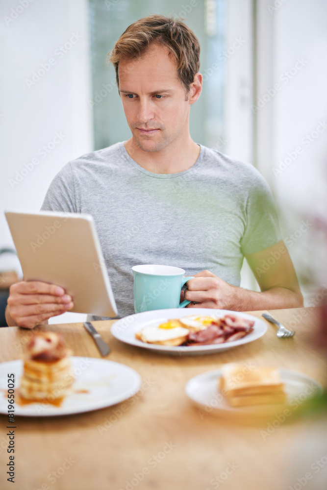 Happy, man and breakfast with tablet at table for morning routine with rest, relax and entertainment on holiday at home. Online, male person and tech for watching tv or streaming movies on vacation Happy, man and breakfast with tablet at table for morning routine with rest, relax and entertainment on holiday at home. Online, male person and tech for watching tv or streaming movies on vacation