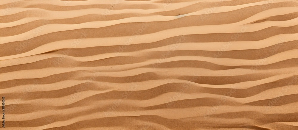 Closeup of a summer beach sand surface with a fine brown sand pattern background for a copy space image Closeup of a summer beach sand surface with a fine brown sand pattern background for a copy space image