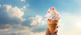 On a sunny day a hand holds a delectable melting ice cream cone creating a delightful scene in a copy space image