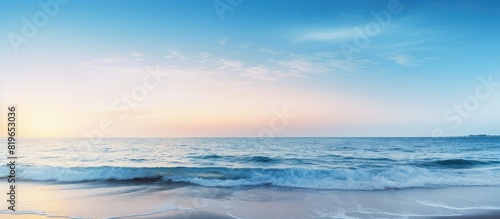 Scenic beach view at dusk with a beautiful sunset and clear blue sky in the background perfect for a copy space image