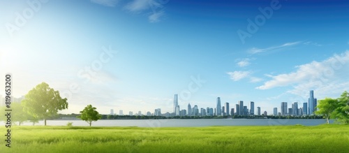Scenic view of a grassy field with buildings and water in the background providing a beautiful copy space image photo