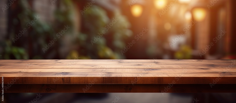The wooden brown table top is set against a blurry background showcasing the house s corridor passage and courtyard perfect copy space image for product displays or designs The wooden brown table top is set against a blurry background showcasing the house s corridor passage and courtyard perfect copy space image for product displays or designs