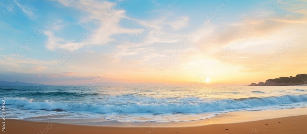 Scenic beach view at dusk with a beautiful sunset and clear blue sky in the background perfect for a copy space image Scenic beach view at dusk with a beautiful sunset and clear blue sky in the background perfect for a copy space image