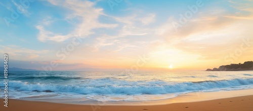 Scenic beach view at dusk with a beautiful sunset and clear blue sky in the background perfect for a copy space image