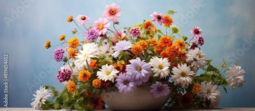 Floristics arrangement of various flowers in a flowerpot suitable for a copy space image