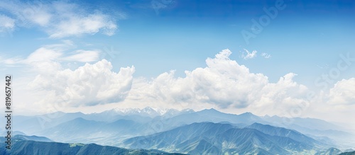 Scenic view with blue sky fluffy white clouds and majestic brown mountains perfect for a copy space image