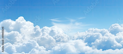 White clouds against a blue sky providing a serene copy space image