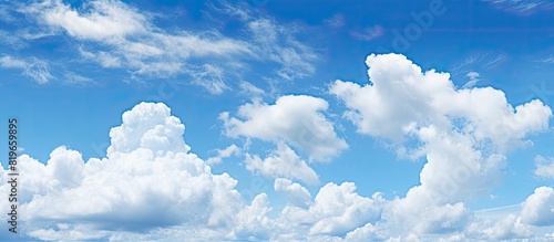 Fototapeta Naklejka Na Ścianę i Meble -  Summer daytime panoramic view of a bright and clear blue sky with fluffy clouds creating an abstract wallpaper background representing the beauty of outdoor nature with copy space image