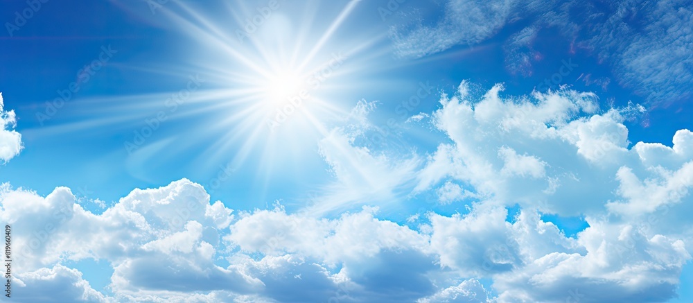Abstract background of blue sky and white clouds with the sun shining. Copy space image. Place for adding text and design Abstract background of blue sky and white clouds with the sun shining. Copy space image. Place for adding text and design