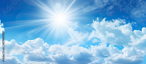 Fototapeta Naklejka Na Ścianę i Meble -  Abstract background of blue sky and white clouds with the sun shining. Copy space image. Place for adding text and design