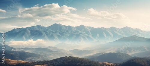 Mountain landscape with an Instagram filter showcasing cloud covered peaks in the background ideal for a copy space image