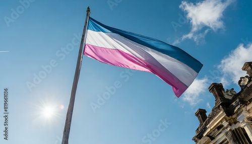 trans flag fluttering against blue sky, lgbt, pride month