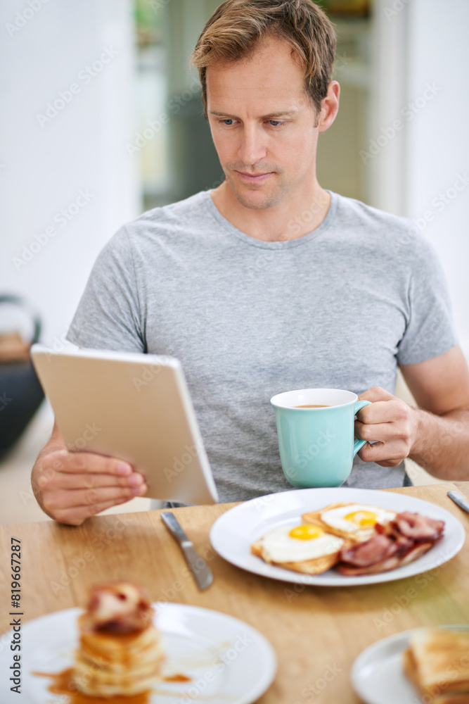 Man, tablet and morning breakfast or reading in home or nutrition meal with coffee, eggs or waffles. Male person, relax and online news in apartment kitchen for relax leisure, streaming or connection Man, tablet and morning breakfast or reading in home or nutrition meal with coffee, eggs or waffles. Male person, relax and online news in apartment kitchen for relax leisure, streaming or connection