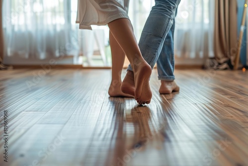 A young couple feet on a hardwood floor
