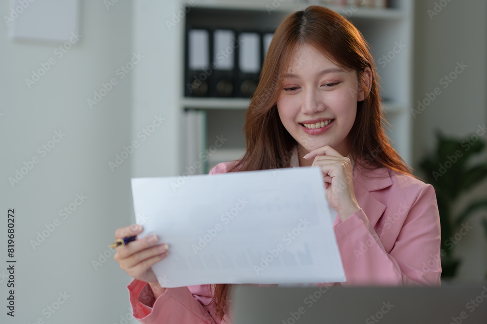 Asian businesswoman working in office with documents and laptop financial documents Sit in your office chair, smile and be happy with your success and results. Ideas for working. Asian businesswoman working in office with documents and laptop financial documents Sit in your office chair, smile and be happy with your success and results. Ideas for working.
