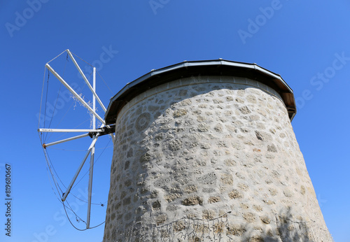 Abandoned Old Greek Windmill with Blue Sky Background in Alacati, Izmir, Turkey