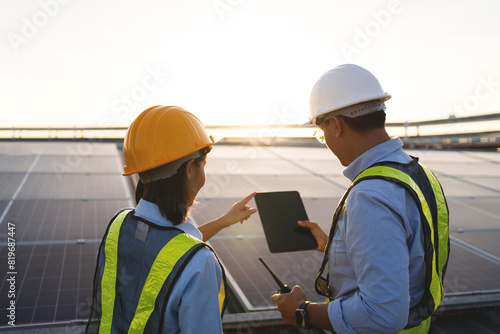 Foto Two people wearing safety gear and pointing at a tablet