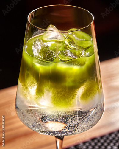 Chilled matcha tonic cocktail in elegant stemmed glass