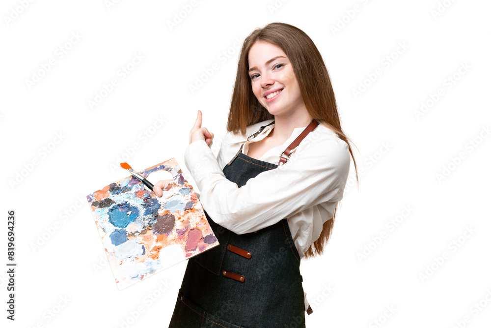 Young artist woman holding a palette over isolated chroma key background pointing back Young artist woman holding a palette over isolated chroma key background pointing back