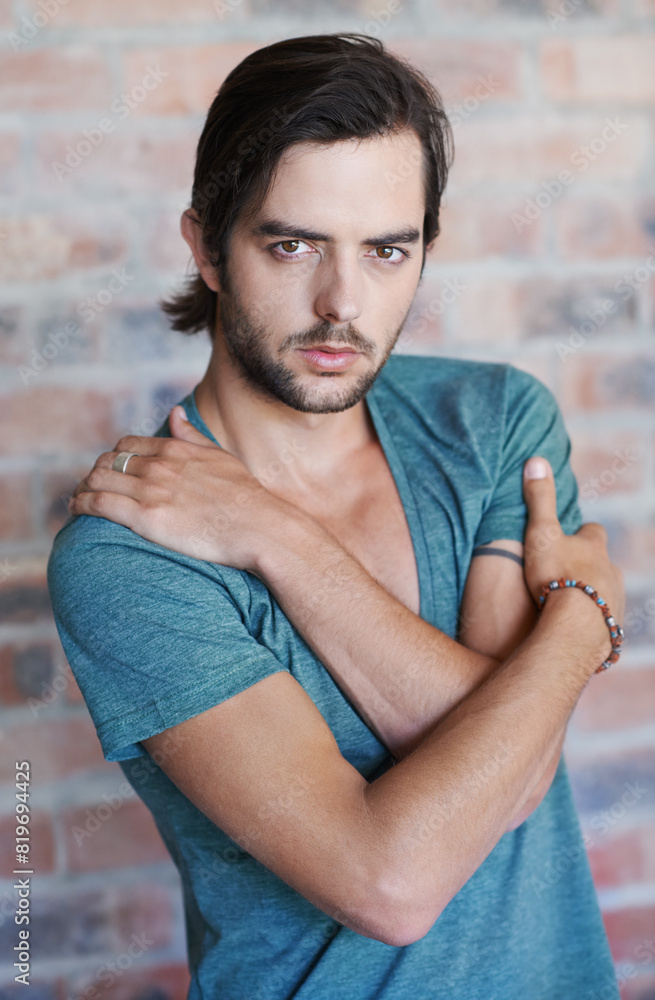 Obraz premium Man, portrait and casual fashion by brick wall with pride, confidence and tshirt for style in Germany. Male person, contemplating and edgy model in trendy outfit for aesthetic. and designer clothes