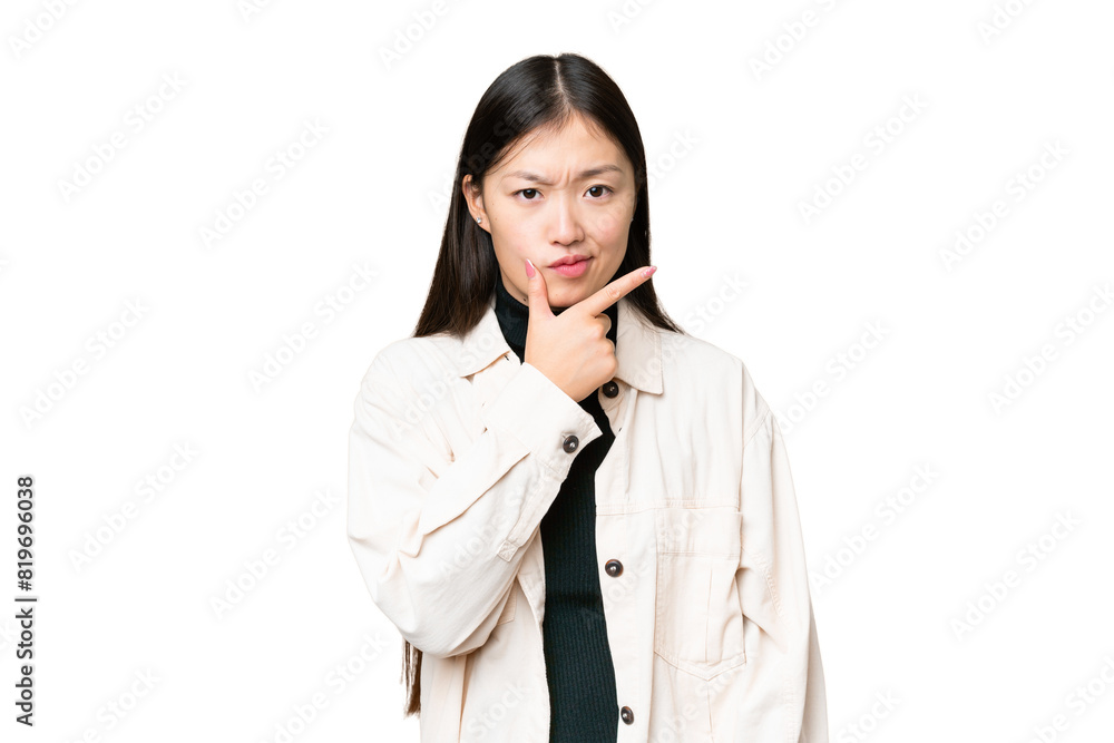 Young Asian woman over isolated chroma key background having doubts Young Asian woman over isolated chroma key background having doubts