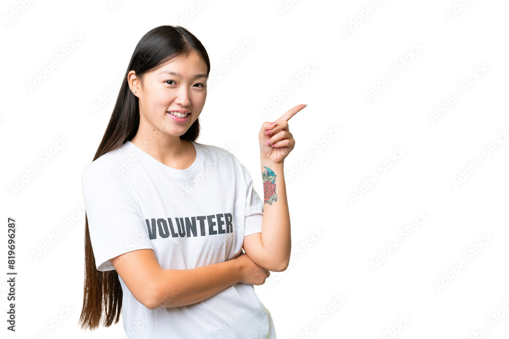 Young volunteer woman over isolated chroma key background pointing finger to the side Young volunteer woman over isolated chroma key background pointing finger to the side