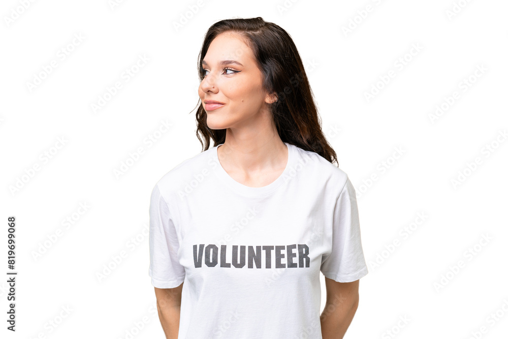 Young volunteer caucasian woman over isolated background looking to the side Young volunteer caucasian woman over isolated background looking to the side