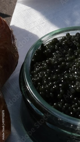 Collect black caviar from a jar, place it on a piece of wood, and eat it. Food on the street Picnic photo