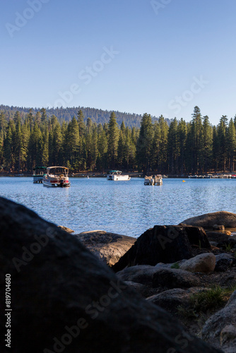 panoramic view over the pinecrest lake with lot of sailing and motor boats on it. At the Stanislaus national forest , california photo