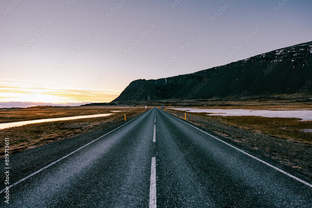 Ring road number 1 in southern Iceland with mountains in the background during sunrise Ring road number 1 in southern Iceland with mountains in the background during sunrise