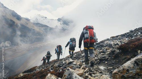 Trekkers navigating a misty and rocky high-altitude mountain trail. photo