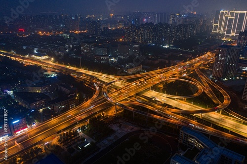 Wallpaper Mural Aerial view of an intersection illuminated by orange-yellow street lights at night. Torontodigital.ca