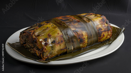 Authentic venezuelan hallaca wrapped in banana leaves, beautifully plated on a white dish set against a dark backdrop photo