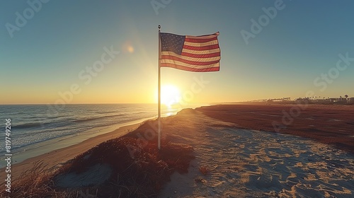 A national flag of the United States waving on a pole against a clear, blue, cloudless sky in daylight photo