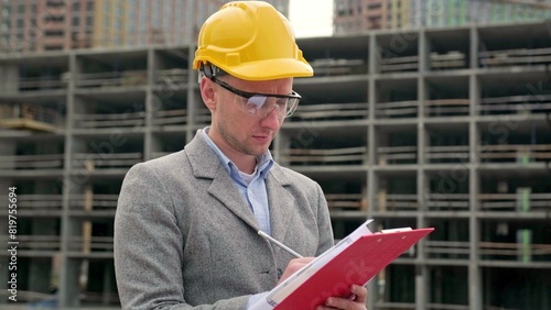 Site inspector dealing with documentation during building object inspection