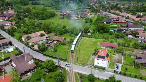 Aerial footage of the Sovata narrow gauge train passing through the houses photo