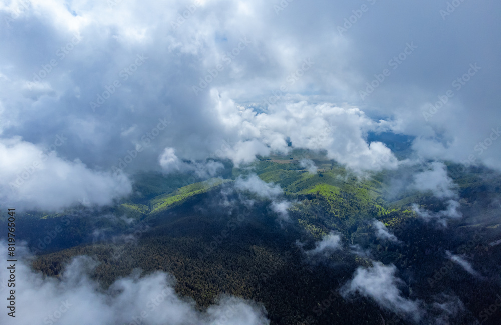 Aerial view of clouds over forested mountains Aerial view of clouds over forested mountains