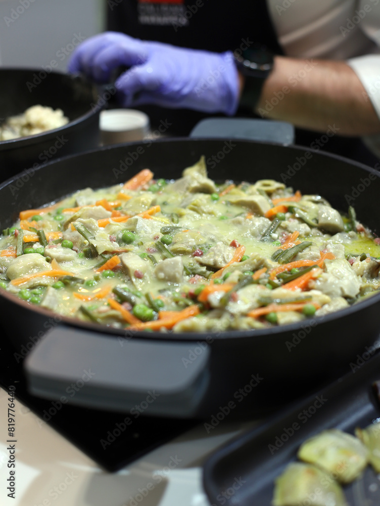 chef cooking a vegetable stew in a casserole chef cooking a vegetable stew in a casserole